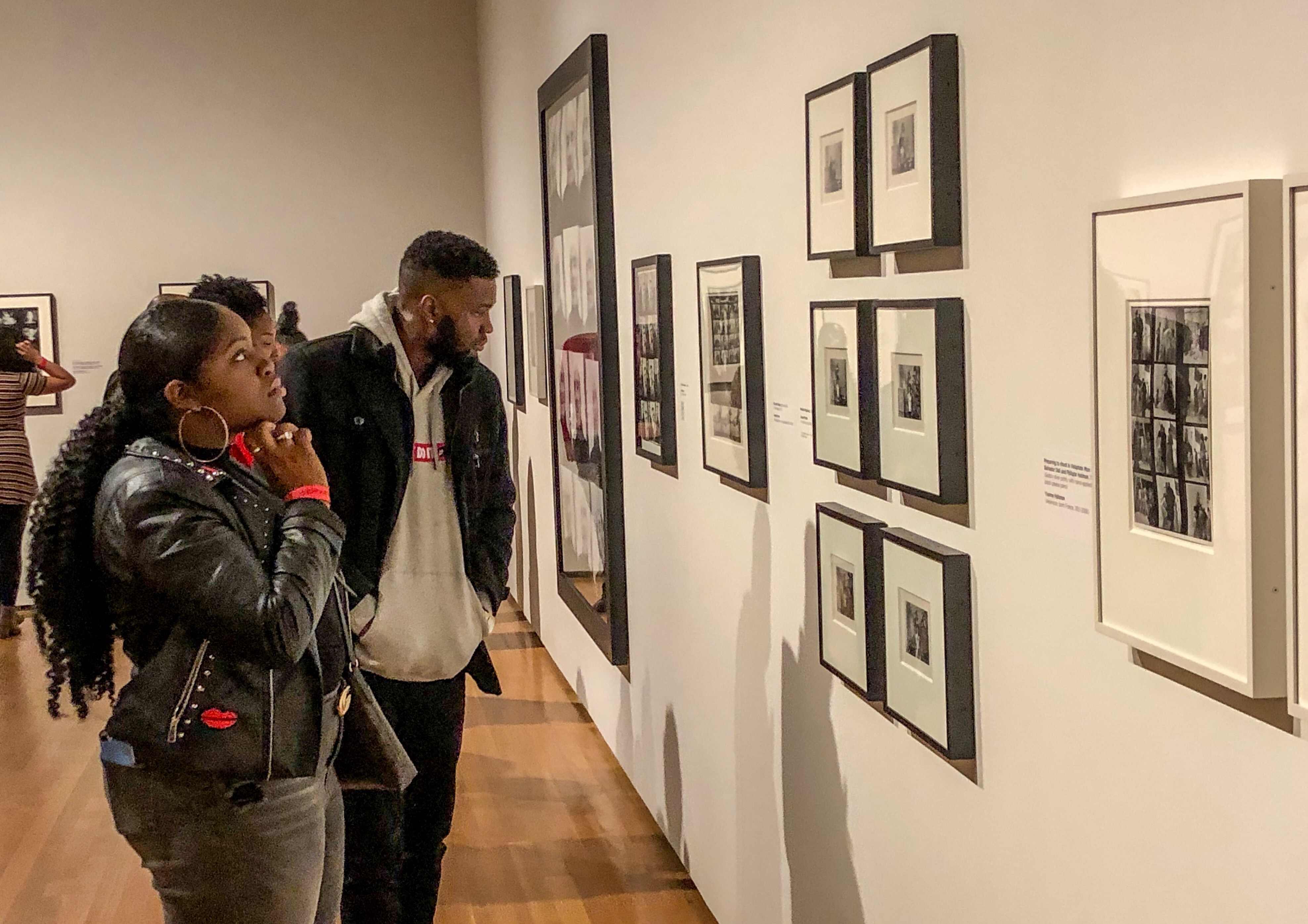 Two Cleveland Museum of Art visitors viewing the PROOF: Photography in the Era of the Contact Sheet exhibition design